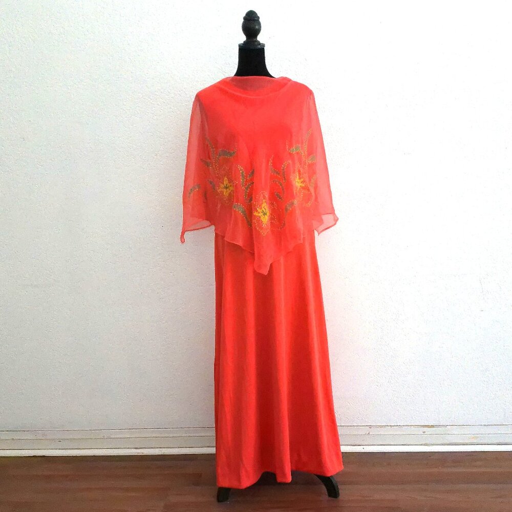 Orange dress with overlay, with green/yellow glitters flower design.